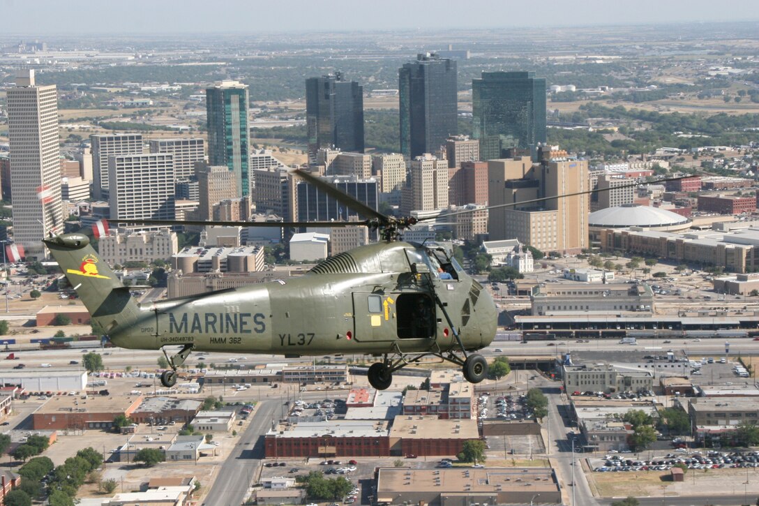 The Flying Memorial, Ugly Angel 'Yankee Lima 37,' a restored H-34 Sea Horse, approaches the downtown skyline of Fort Worth, Texas, during the 3rd Annual Cowtown Warbird Roundup held at Meacham Airport Aug. 11 and 12, an event that benefited the OV-10 Bronco Association, Forward Air Controller's Museum and the Vintage Flying Museum. Photo by Sgt. Joshua A. Tate