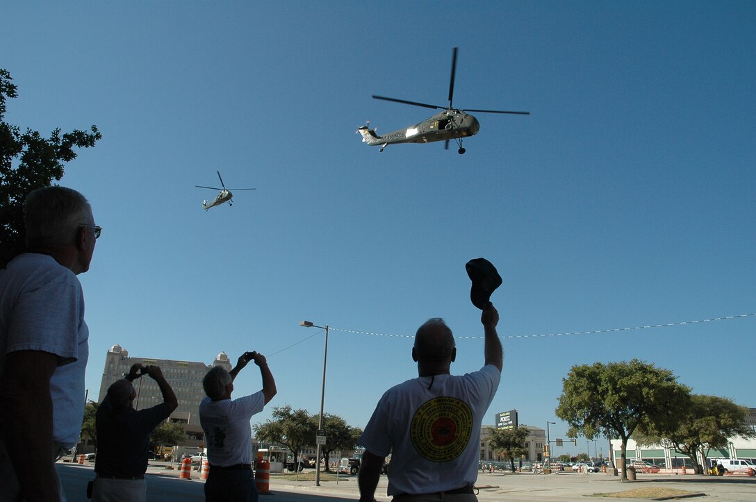 Two H-34 Sea Horse helicopters fly through downtown Fort Worth, Texas, during the biennial U.S. Marine Corps Combat Helicopter Association reunion held at the convention center Aug. 11. 'Pop A Smoke' coincided with the 3rd Annual Cowtown Warbird Roundup held at Meacham Airport in Fort Worth, Texas, Aug. 12, an event that benefited the OV-10 Bronco Association, Forward Air Controller's Museum and the Vintage Flying Museum. Photo by Sgt. Joel A. Chaverri