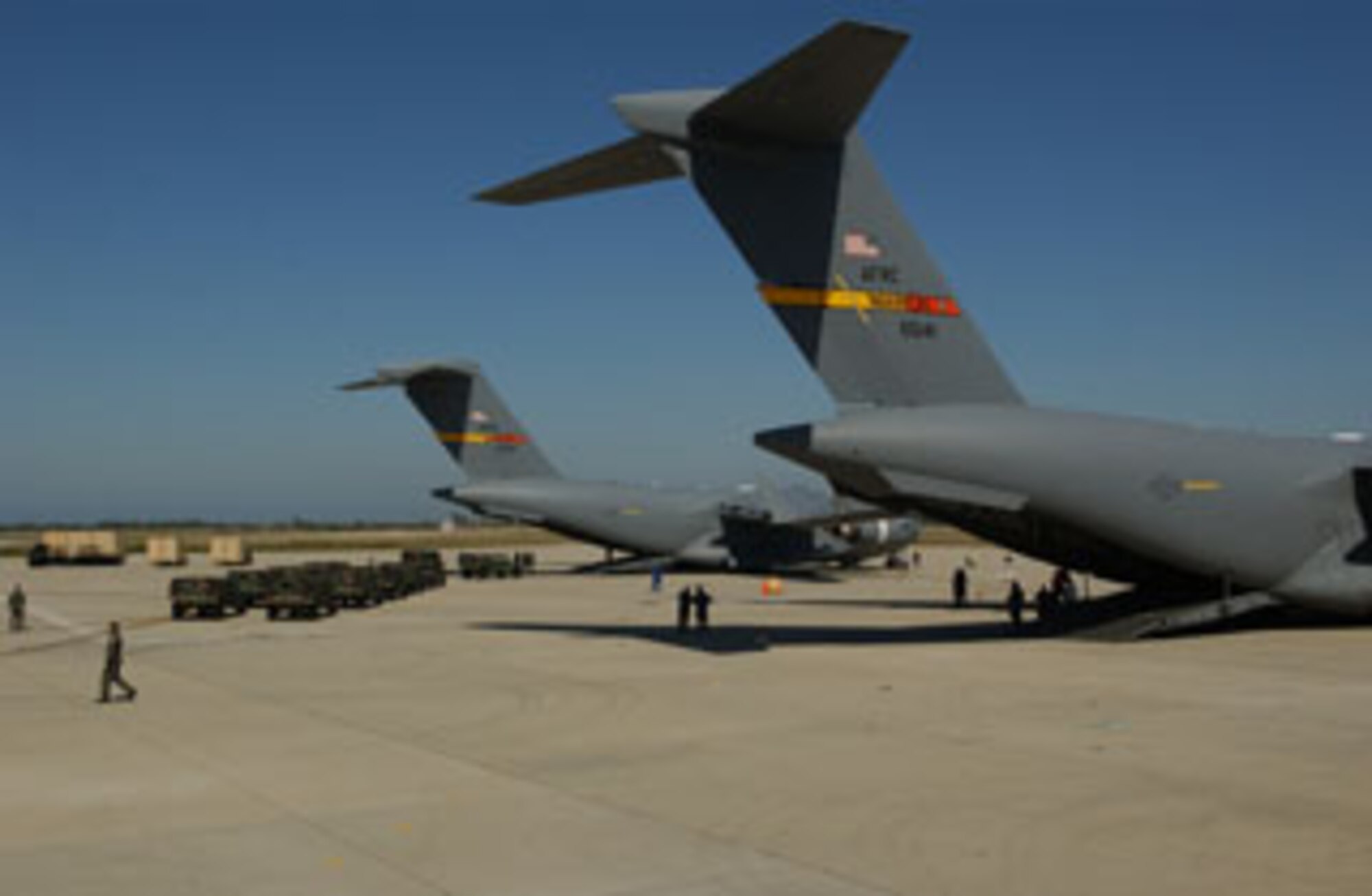 HMMWVs (High-Mobility Multipurpose Wheeled Vehicle) approach a C-17 Globemaster III from March Air Reserve Base for upload on July15, 2006 at Pt Mugu Naval Air Station, Calif., during the 304th Sustainment Brigade Movement. The primary mission is to move the 304th SBDE from Pt Mugu to March Air Reserve Base.The exercise included training for command and control, air to ground airlift and tanker communications, equipment preparation, joint inspection and rapid simultaneous onload of 5 C-17 chalks of outsized cargo and maintenance recovery and parking planning. (USAF photo by Senior Airman Francisco V. Govea II)