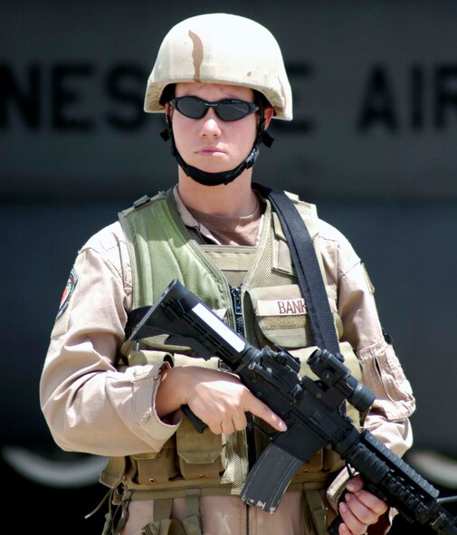 Staff Sgt. Gloria Banks watches for suspicious activity while guarding a C-130 Hercules at an airstrip near Farah, Afghanistan, Aug. 10. She is part of the 455th Expeditionary Security Forces Squadron's Fly-Away Security Team, which protects aircraft and crews throughout Afghanistan. (U.S. Air Force photo/Maj. David Kurle)