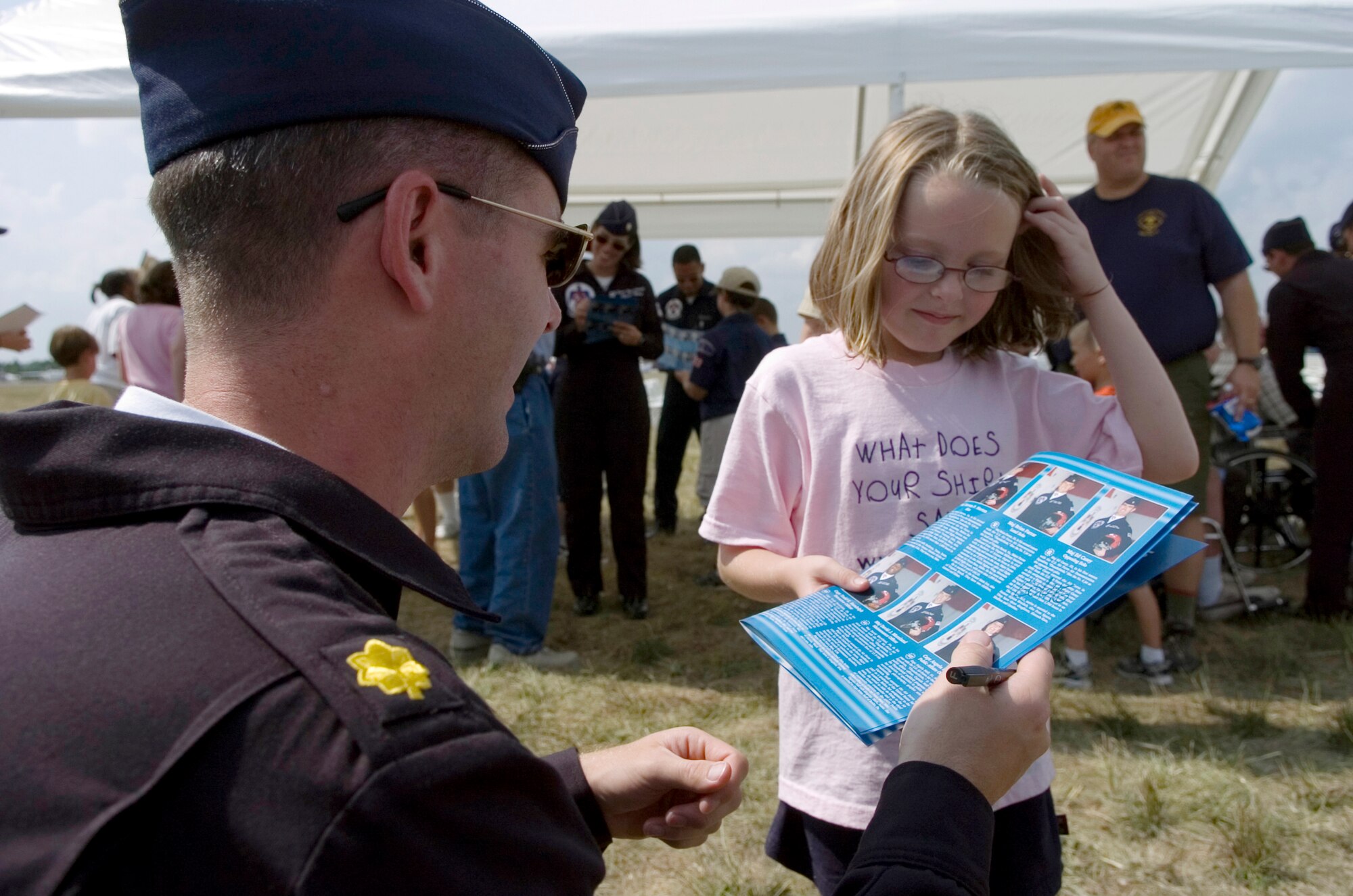 Six-year-old Ashley Cones, from Belleville, Ill., asks Thunderbird #6, Maj. Ed Casey, for an autograph at Scott Air Force Base, Ill.  Major Casey is the opposing solo for the 2006 Thunderbird team. (U.S. Air Force photo/Master Sgt. Jack Braden) 