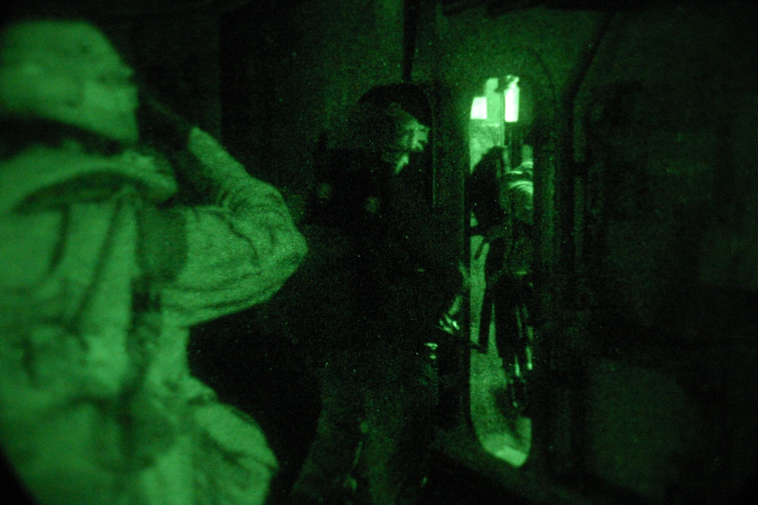 ABOARD USS BOXER (Aug. 12, 2006) -- Marines with Mortar's Platoon, Weapon's Co., Battalion Landing Team 2/4, walk through a hatch after completing a helicopter Tactical Recovery of Aircraft Personnel exercise . BLT 2/4 is participating for Joint Task Force Exercise in support of the 15th Marine Expeditionary Unit. JTFEX is the final evaluation for the MEU, in which their capabilities as a Marine Air Ground Task Force are tested.