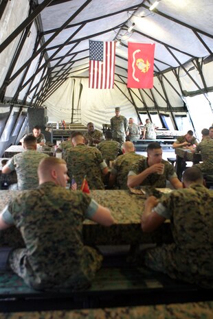 MARINE CORPS BASE CAMP LEJEUNE, N.C. (Aug. 14, 2006) - Marines with Food Service Company, Headquarters Battalion, Combat Logistics Regiment 27, 2nd Marine Logistics Group, eat in the field dining facility they erected as part of a Marine Corps wide competition Aug. 14. Food service units with 2nd Marine Division, Marine Corps Air Station Cherry Point, N.C., and 2nd MLG will compete for the winning spot in II Marine Expeditionary Force, which will be released Sept. 1. The winner of the II MEF competition will move on to compete with food service units Marine Corps wide.