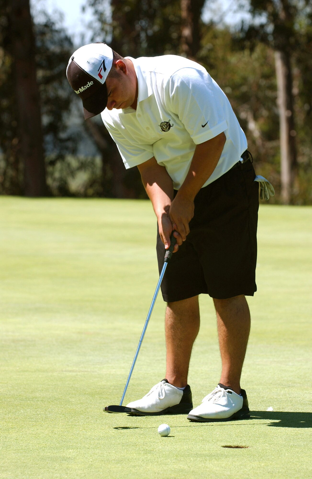 The Air Force's Arnell Garza putts for birdie during the 2006 Armed Forces Golf Championship at Vandenberg Air Force Base, Calif., on Aug. 9.  Air Force golfers took top honors in tournament, winning the men's and women's team competitions as well as the individual men's and women's competitions.  Garza is stationed at Fairchild Air Force Base, Wash. (U.S. Air Force photo/Senior Airman Vanessa Valentine)