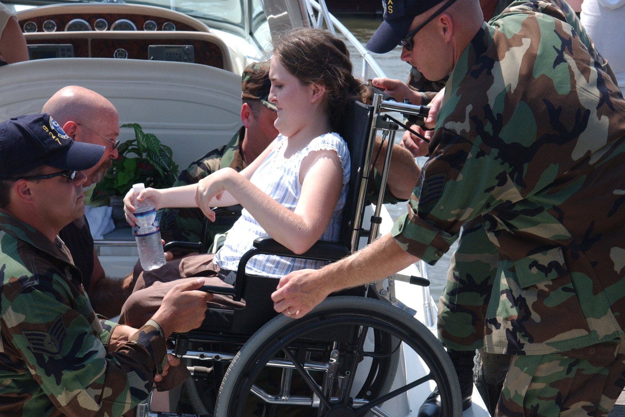 Airmen from the 927th Air Refueling Wing (Air Force Reserve) at Selfridge Air National Guard Base, Mich., assist a muscular dystrophy patient onto a boat shortly before getting underway for the annual boat outing hosted by the Huron Pointe Yacht Club. Wing members have volunteered their services for the past 23 years.