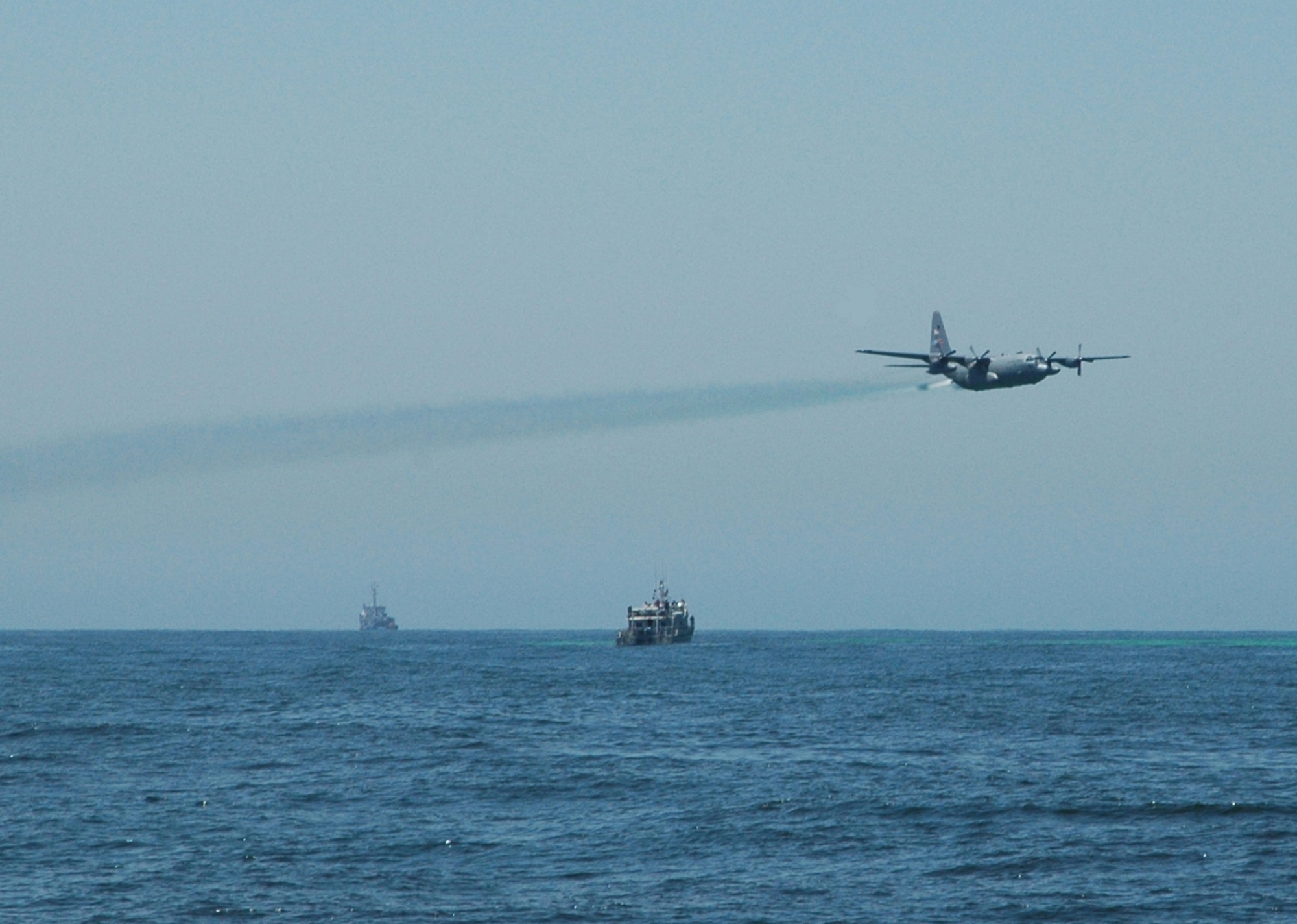 THE GULF OF THE FARALLONES-- A specially-modified C-130H Aerial Spray aircraft and crew assigned to the Air Force Reserve's 910th Airlift Wing conducts several passes spraying water simulating an oil spill dispersant in support of the Safe Seas 2006 Oil Spill Response Exercise held Aug. 9 in the Pacific Ocean off shore of San Francisco.  U.S. Air Force photo/Capt. Brent Davis