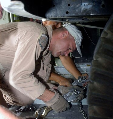Master Sgt. Jeff Springsteen secures a four-wheel drive vehicle in the back of a C-130 Hercules cargo plane in Kabul, Afghanistan, Aug. 10.  Sergeant Springsteen is a C-130 loadmaster from the Delaware Air National Guard's 142nd Airlift Squadron, currently deployed to the 774th Expeditionary Airlift Squadron at Bagram Airfield, Afghanistan.  C-130s provide the bulk of the airlift and airdrop to re-supply U.S. and Coalition forces throughout Afghanistan.  The 774th EAS is manned by Air Guardsmen from Delaware, Alaska, Tennessee, Texas, Nevada, Wyoming, Arkansas and Puerto Rico.  (US Air Force photo/Maj. David Kurle)