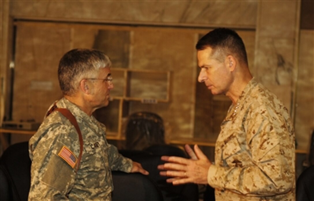 Chairman Joint Chiefs of Staff Gen. Peter Pace (right), U.S. Marine Corps, and Army Gen. George Casey, commander of Multinational Forces Iraq, discuss current military events at Baghdad International Airport, Iraq, on Aug. 12, 2006.  Pace is in Iraq to meet with Casey, other U.S. military commanders and to visit U.S. troops.  