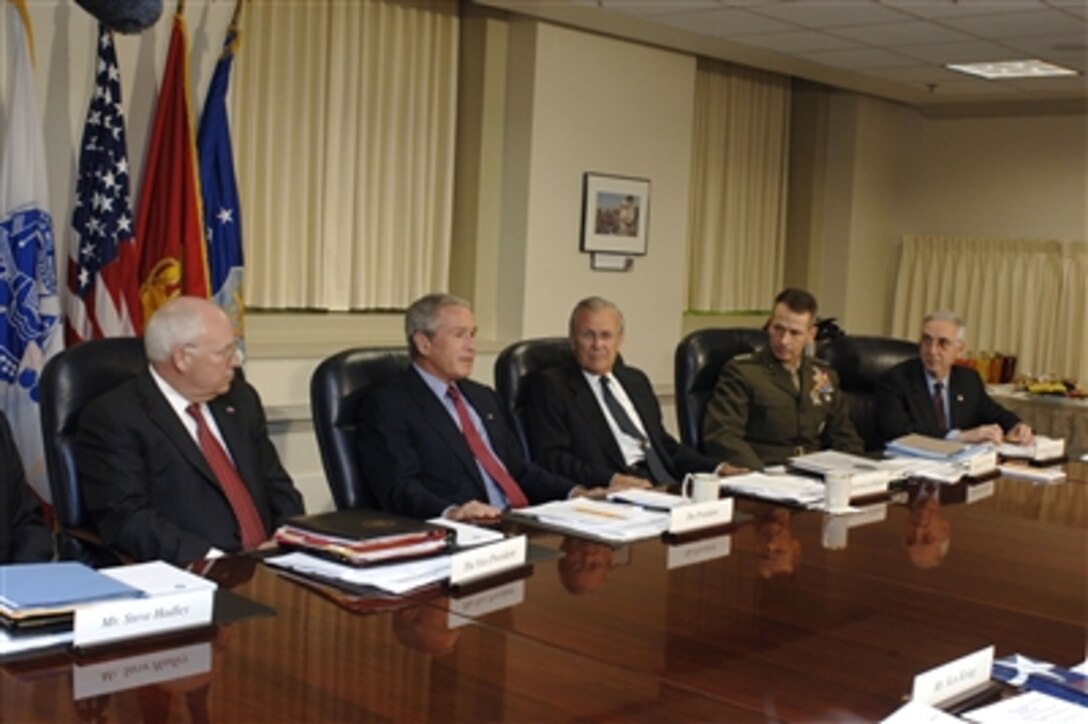 President George W. Bush talks to reporters before beginning his meeting with Secretary of Defense Donald H. Rumsfeld (third from left) and his staff in the Pentagon on Aug. 14, 2006.  Vice President Dick Cheney (left), Chairman Joint Chiefs of Staff Gen. Peter Pace (second from right), U.S. Marine Corps, and Deputy Secretary of Defense Gordon England (right) joined Bush and Rumsfeld to discuss the way ahead in Iraq and the war on terror.  