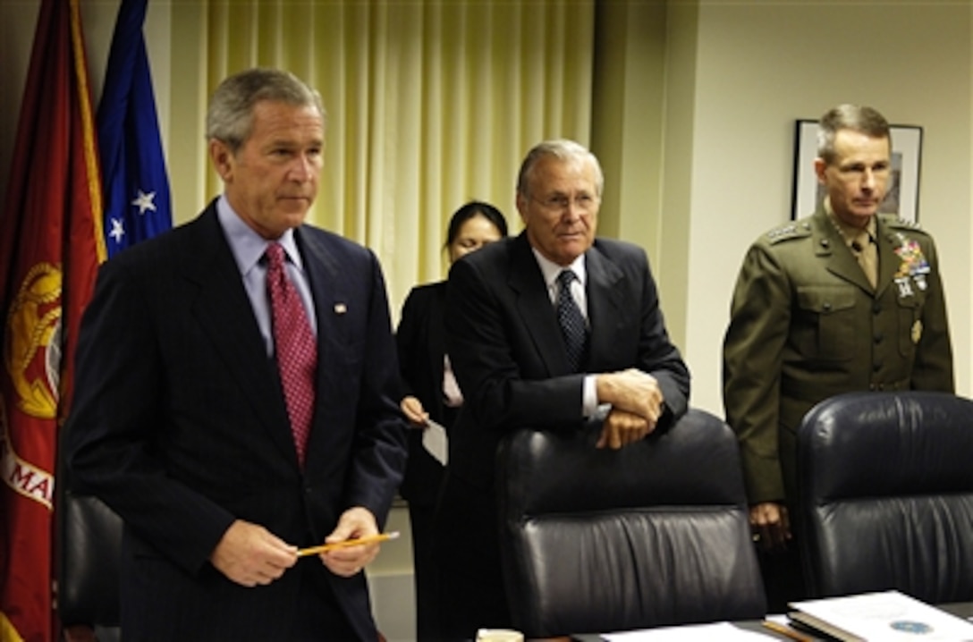 President George W. Bush, Secretary of Defense Donald H. Rumsfeld and Chairman of the Joint Chiefs of Staff Gen. Peter Pace, U.S. Marine Corps, prepare for the beginning of the national security briefing in the Pentagon on Aug. 14, 2006.  Vice President Dick Cheney and Deputy Secretary of Defense Gordon England joined Bush, Rumsfeld and Pace to discuss the way ahead in Iraq and the war on terror. 