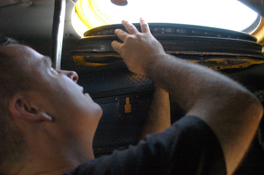 Technical Sgt. David Evans, 317th AMXS crew chief, opens up the cover to the roof of a C-130.                            