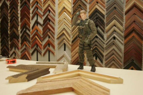 Decisions, decisions... Viper scratches his head as he debates which type of frame wood would work best for a customized project at the base's arts and crafts center.  Located in Bldg. 2806 next to the bowling center, the arts and crafts center features custom framing and matting class for beginners in addition to hundreds of frames and mattes for all types of projects.  The center is also home to a fully stocked wood hobby shop, custom engraving center and arts and crafts supply store.  For more information, call the center at 828-6680.