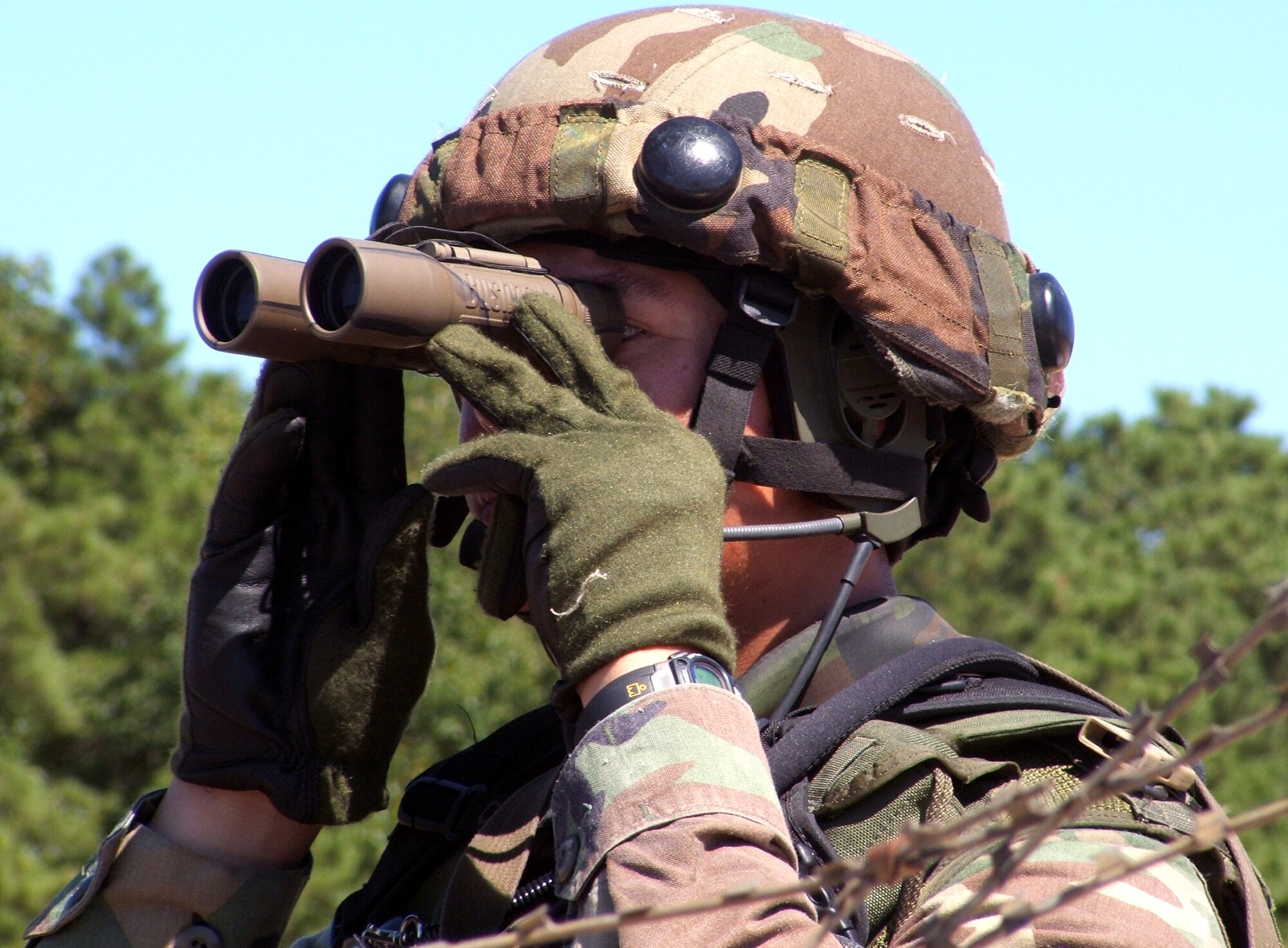 Master Sgt. Michael Lawrence scans an area for "enemy forces" during an Eagle Flag 06-4 scenario at Naval Air Engineering Station Lakehurst, N.J., on Aug. 12. The events, controlled by the Air Mobility Warfare Center's 421st Combat Training Squadron, test Airmen on their expeditionary combat support skills in preparation for deployments. Sergeant Lawrence is stationed at Travis Air Force Base, Calif. (U.S. Air Force photo/Tech. Sgt. Scott T. Sturkol)