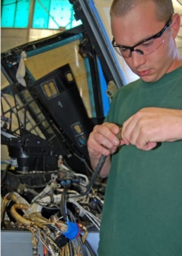John Shuma rewires the cockpit of an A-10 Thunderbolt II at Hill Air Force Base, Utah. The work is part of the precision engagement modification program managed by the 309th Aircraft Maintenance Group. Once completed, the aircraft will include 10 new components, while another 12 will be upgraded. Mr. Shuma is an aircraft electrician with L3 Communications. (U.S. Air Force photo/G.A. Volb)