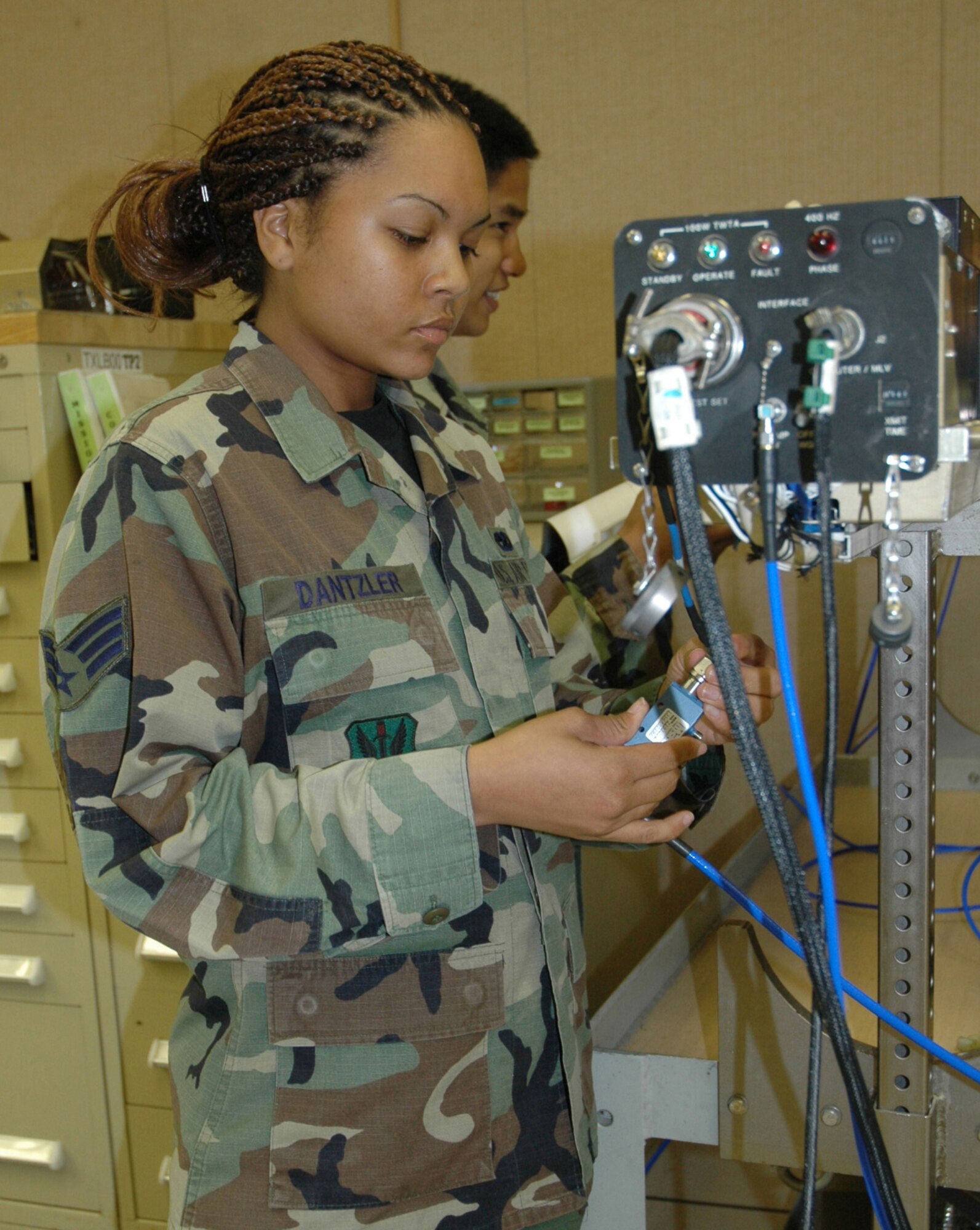 TYNDALL AIR FORCE BASE, Fla. (AETCNS) -- Senior Airman Jennifer Dantzler, 28th Test Squadron/Detachment 2 electronic warfare technician, hooks up wires to an electronic warfare defense pod used on Air Force fighter jets. The squadron, one of Tyndall’s tenant units, won the Air Force Association’s 2006 Theodore Von Karman Award for outstanding contributions to national defense in the field of science and engineering related to aerospace activities. Electronic warfare systems and its associated capabilities are part of more than 400 test missions in support of 17 programs accomplished in 2006 across the combat Air Forces. Specifically, the pod in the picture is an essential tool for testing and training on F-15 and F-16 aircraft radar and avionics suites. (U.S. Air Force photo by Chrissy Cuttita) 