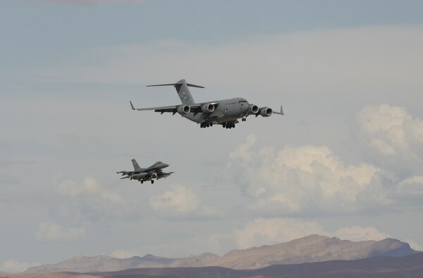 A C-17 from McChord AFB, Wash., and an F-16CJ from Cannon AFB, N.M., come in to land on the parallel runways at Nellis AFB, Nev., Aug. 14 during Red Flag. The exercise, which ends Sept. 2, puts up to 80 aircraft in the air at one time to train crews in large-force operations in a highly realistic combat environment. (Photo courtesy Paul Ridgway)