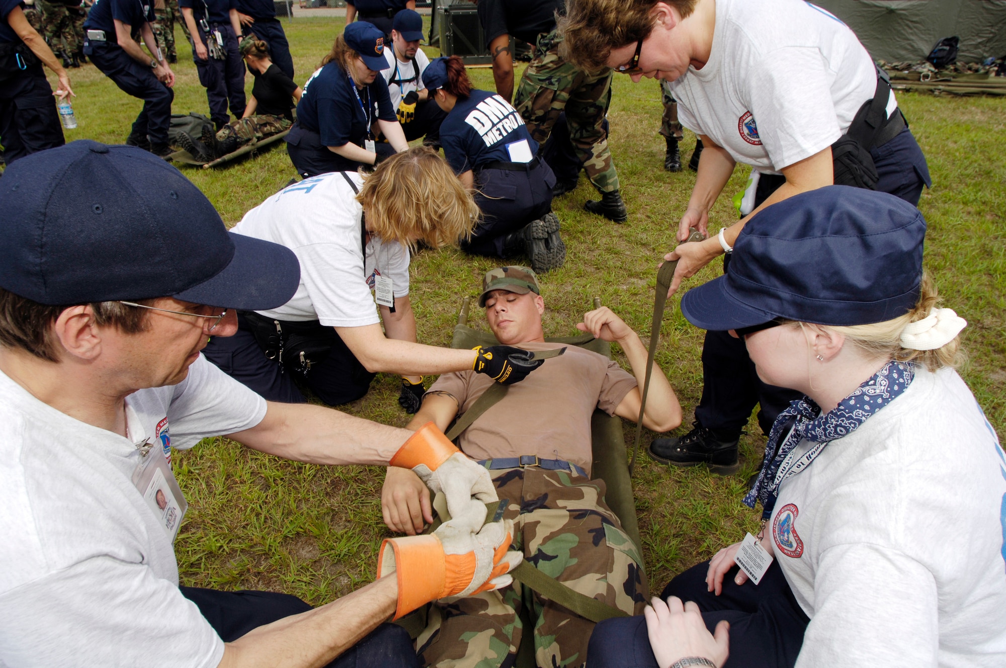 Staff Sgt. Justin Ashjian, 305th Dental Squadron dental lab apprentice and mock patient, is placed into a gurney by Federal Emergency Management Agency personnel members during a medical readiness exercise Aug. 4 at Fort Dix.  Photo by Denise Gould