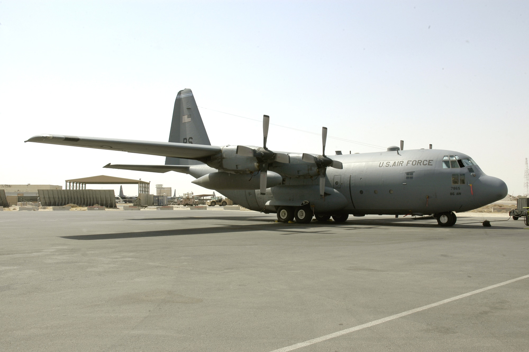 Aircraft 63-7865, a C-130 Hercules deployed from Ramstein Air Base, Germany, sits on the flightline at a forward operating base in Southwest Asia. The aircraft features a plaque telling its story of being a Purple Heart recipient. (U.S. Air Force photo/Staff Sgt. Ryan Hansen)
