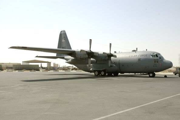 Aircraft 63-7865, a C-130 Hercules deployed from Ramstein Air Base, Germany, sits on the flightline at a forward operating base in Southwest Asia. The aircraft features a plaque telling its story of being a Purple Heart recipient. (U.S. Air Force photo/Staff Sgt. Ryan Hansen)