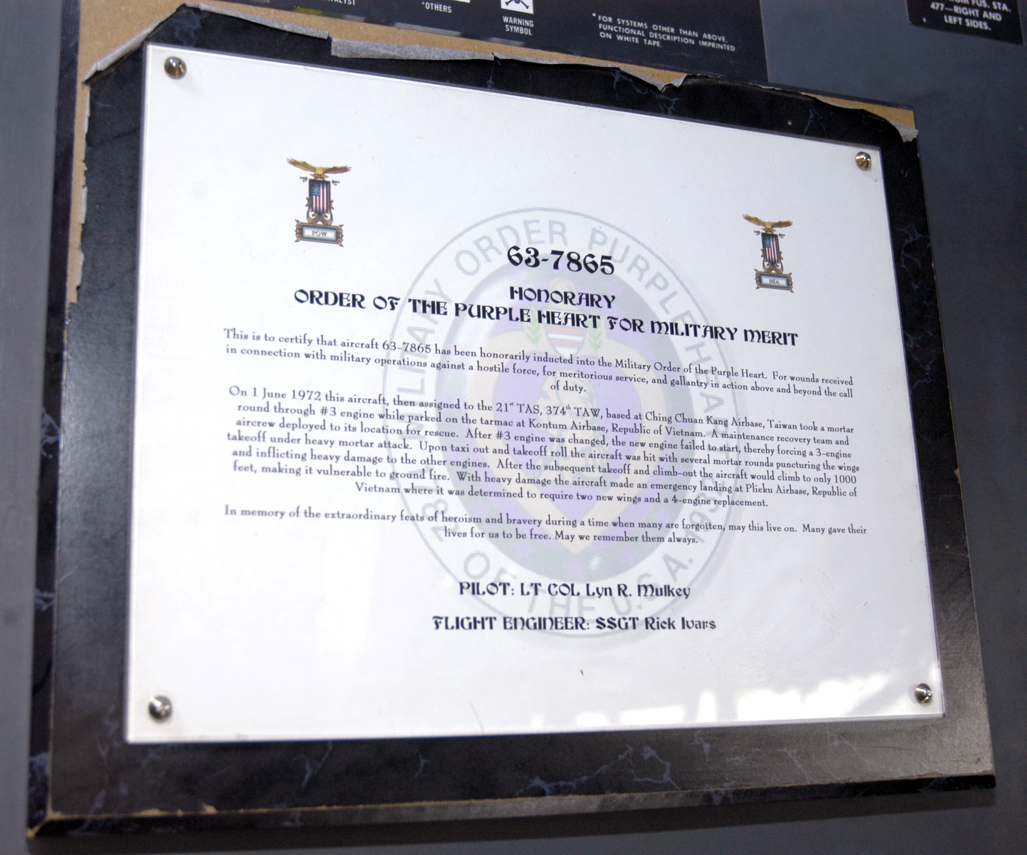 Aircraft 63-7865, a C-130 Hercules deployed from Ramstein Air Base, Germany, has a plaque telling its story of being a Purple Heart recipient. The C-130 is deployed to a forward operating base in Southwest Asia. (U.S. Air Force photo/Staff Sgt. Ryan Hansen)