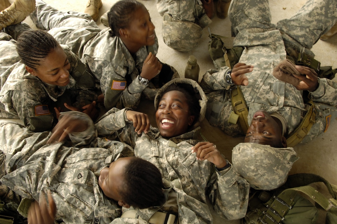 U.S. Army trainees laugh and sing songs together after a field training exercise during basic combat training at Fort Jackson, S.C., Aug. 9, 2006. 
