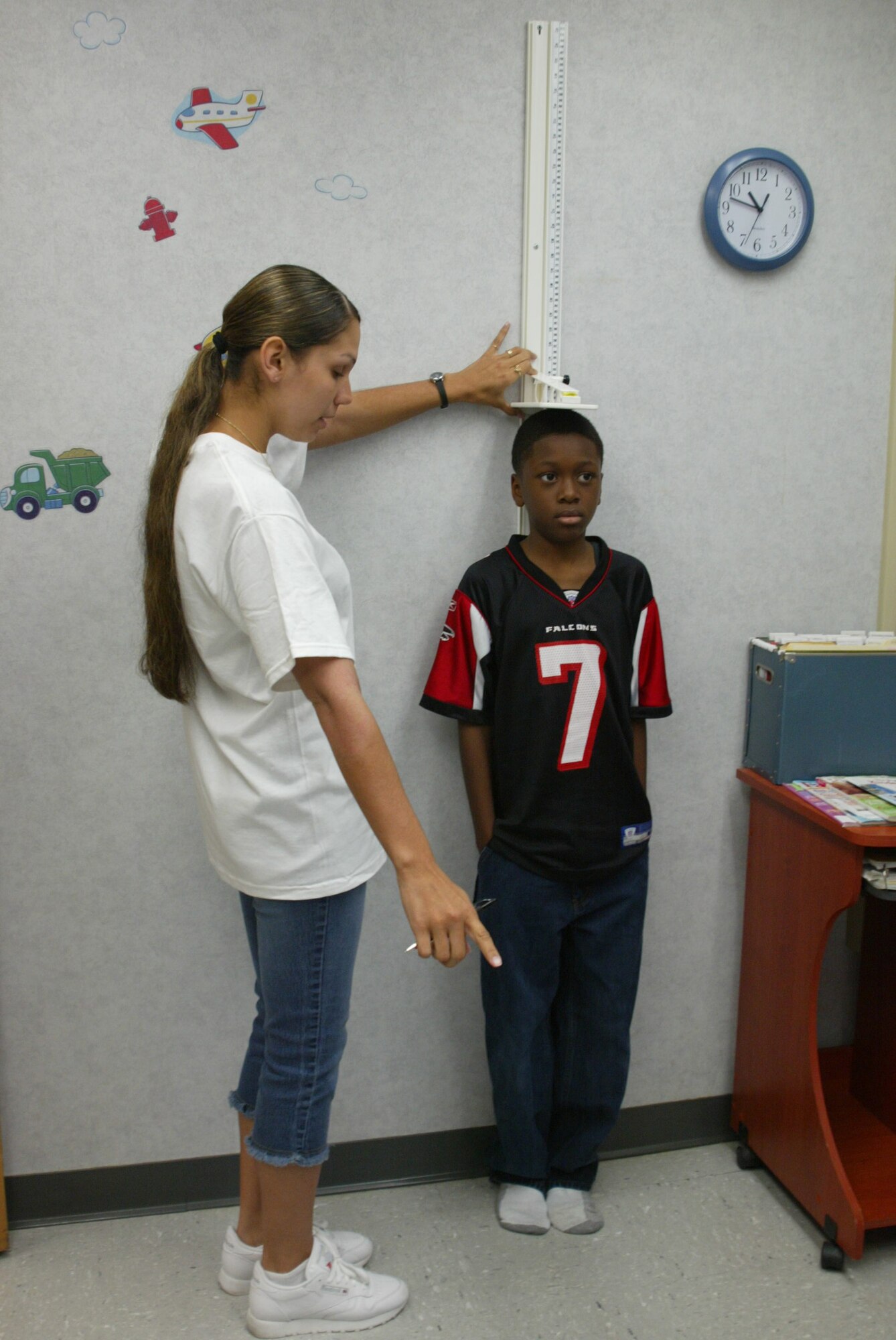 POPE AIR FORCE BASE , N.C. -- Staff Sgt. Amanda Ruiz, 43rd Medical Group, checks the height of fifth grader D'ante Scruggs Saturday.  (U.S. Air Force photo/Lisa Terry McKeown)