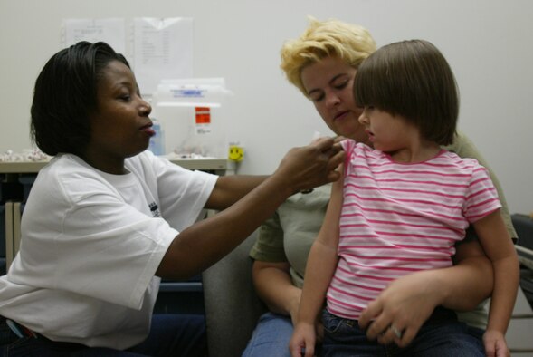 POPE AIR FORCE BASE , N.C. -- Gabby Drake prepares to recieve her immunizations as her mom tries to keep her calm. More than 200 Pope youth received immunixations and physicals in the bases's first back to school health fair Saturday. (U.S. Air Force photo/Lisa Terry McKeown)