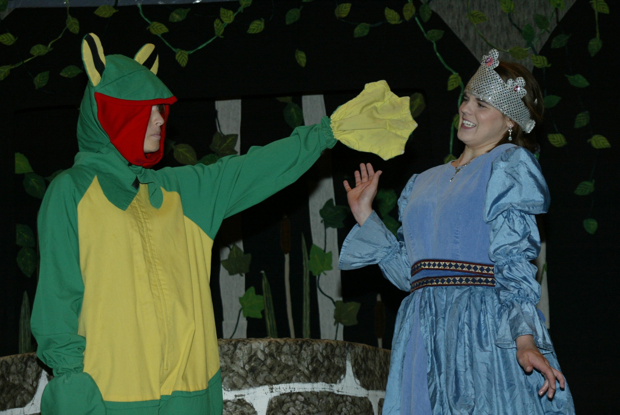 POPE AIR FORCE BASE , N.C. -- The Frog, played by Erica O'Brien, coaxes Princess Prim, played by Britanny Willis, into letting her retrieve the gold ball the princess dropped down the well. The youth were preparing for Saturday's performance of The Frog Prince. (U.S. Air Force photo/Lisa Terry McKeown)