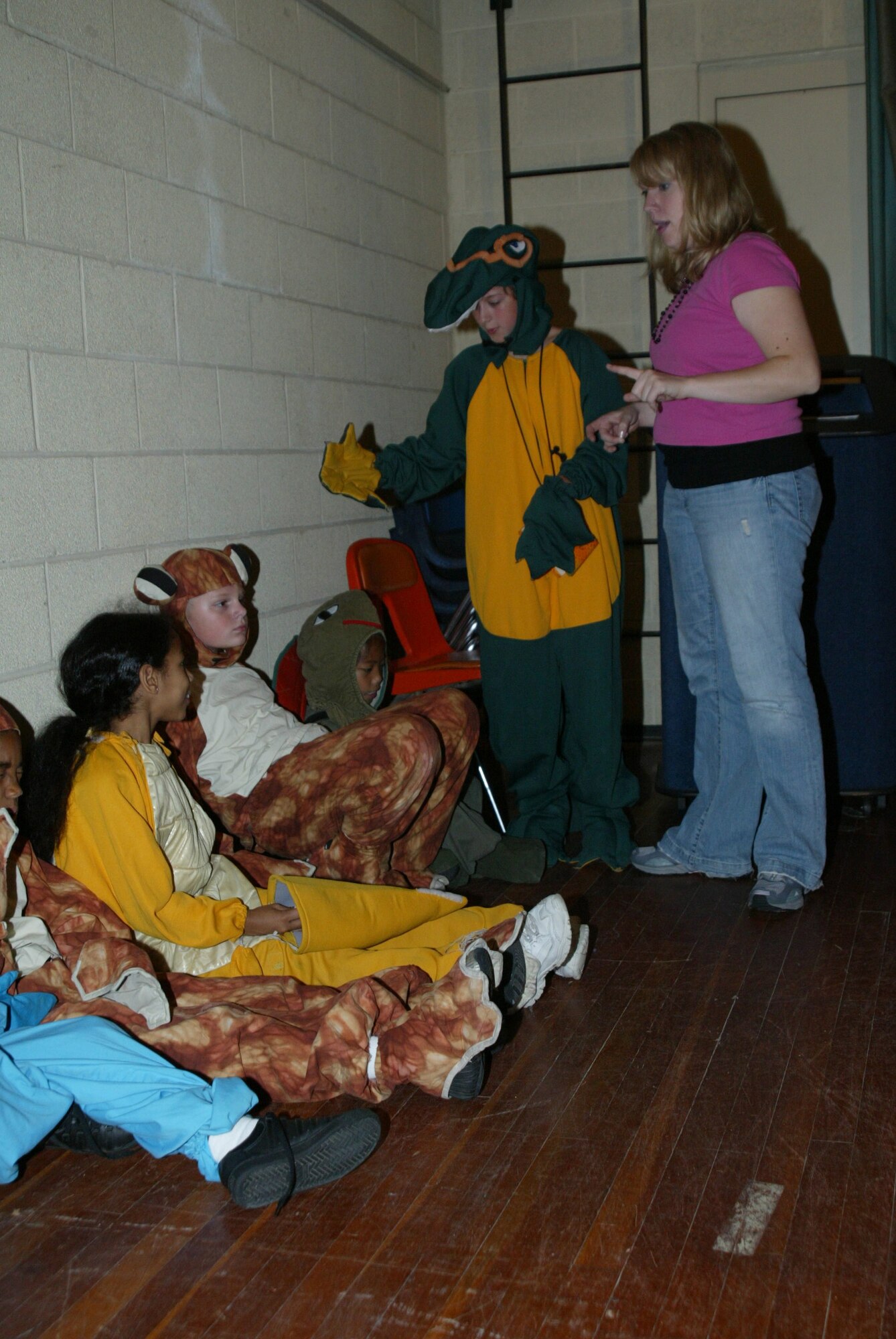 POPE AIR FORCE BASE , N.C. -- Missoula Children's Theater instructor Coery Roberts helps the young actors understand when they enter their scene from backstage.  (U.S. Air Force photo/Lisa Terry McKeown)