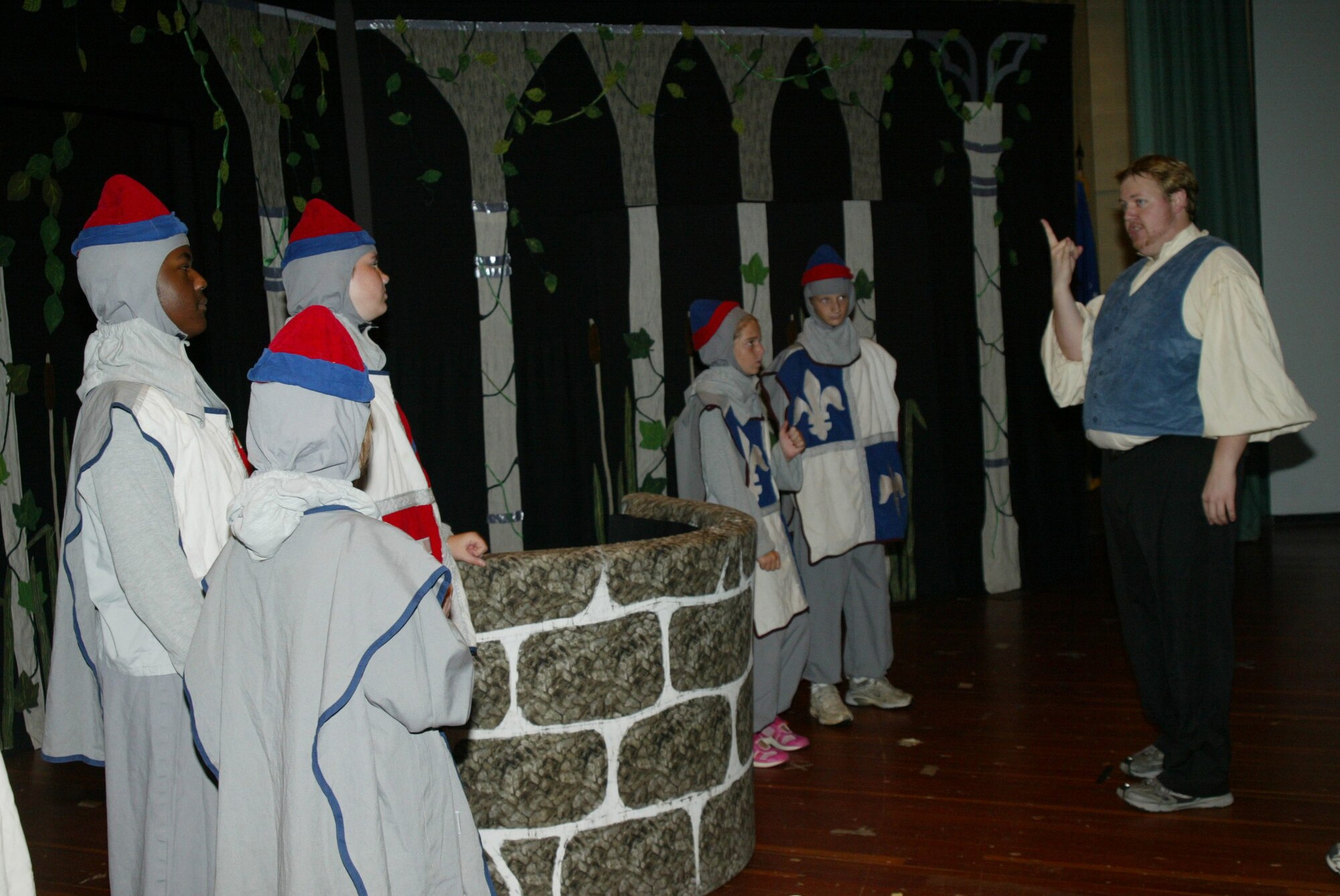 POPE AIR FORCE BASE , N.C. -- David Weinheimer, a Missoula Children's Theater instructor, teaches the knights the hand signals for scene changes. (U.S. Air Force photo/Lisa Terry McKeown)