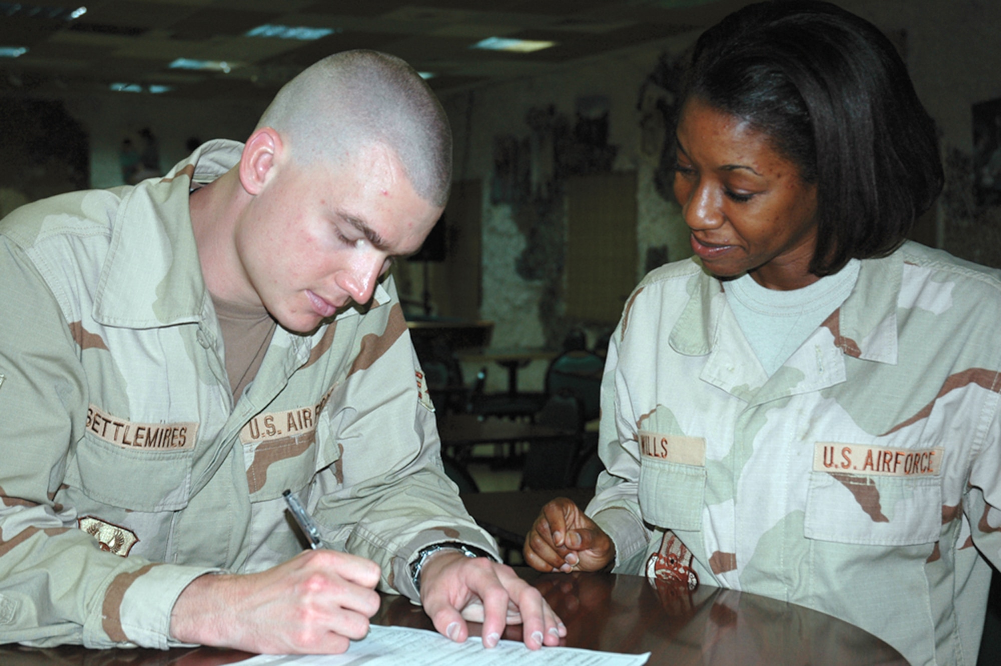 Tech. Sgt. Rochelle Wills assists Senior Airman Pat Settlemires in filling out his registration consent form during a bone marrow registration drive at a forward operating base in Southwest Asia. The drive was organized by a deployed Airman in memory of her son, who lost his battle with acute lymphoblastic leukemia last September. The drive drew 685 new registrants to the national donor registry. Sergeant Wills and Airman Settlemires are with the 379th Air Expeditionary Wing. (U.S. Air Force photo/Staff Sgt. Celena Wilson)