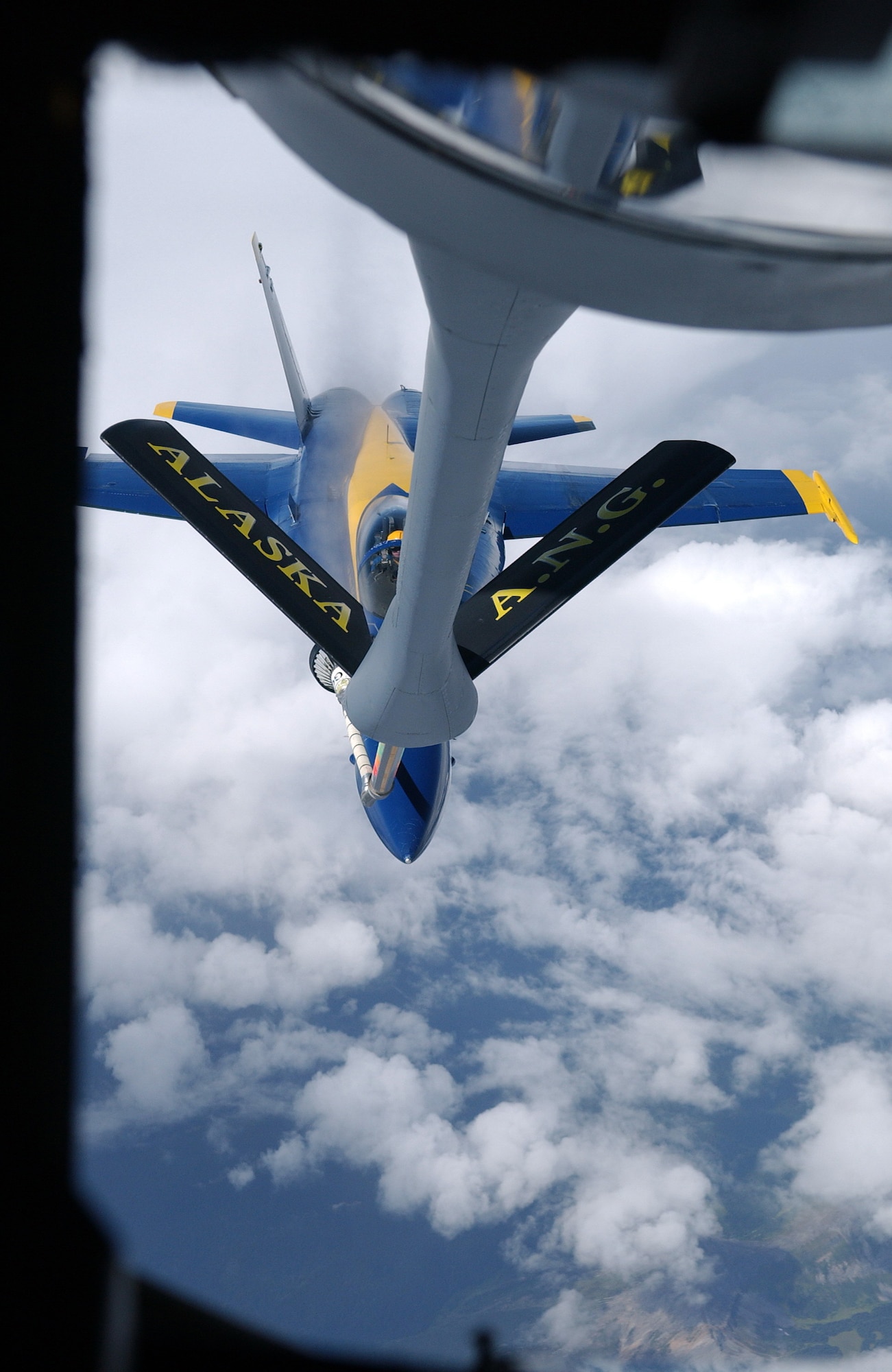 A KC-135 Stratotanker refuels an F/A-18 Hornet from the Navy's Blue Angels on its way from an air show at Elmendorf Air Force Base, Alaska, on Aug. 14. The KC-135 is with the 168th Air Refueling Wing at Eielson AFB, Alaska. (U.S. Air Force photo/Senior Airman Anthony Nelson Jr.)
