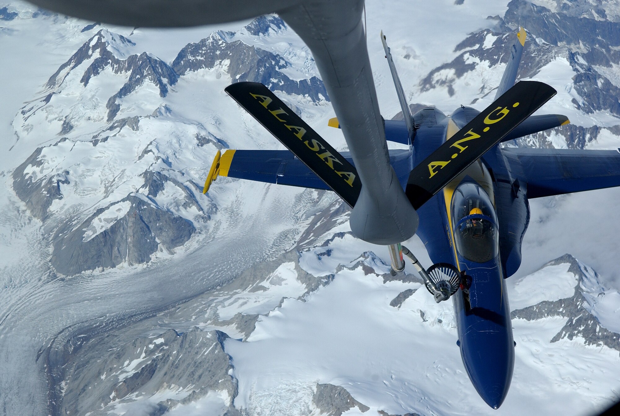 A KC-135 Stratotanker refuels an F/A-18 Hornet from the Navy's Blue Angels on its way from an air show at Elmendorf Air Force Base, Alaska, on Aug. 14. The KC-135 is with the 168th Air Refueling Wing at Eielson AFB, Alaska. (U.S. Air Force photo/Senior Airman Anthony Nelson Jr.)
