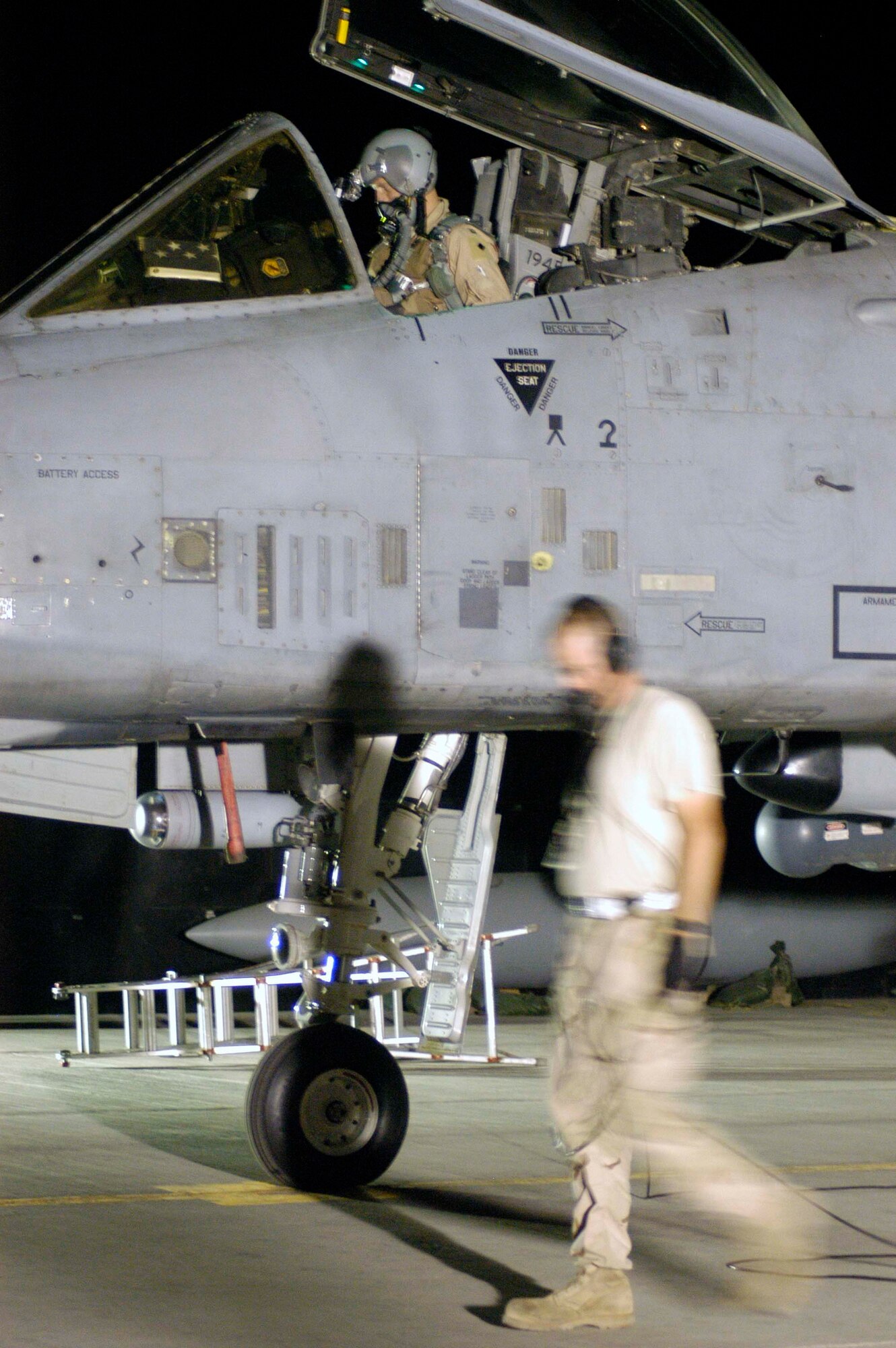 Capt. Rick Mitchell, pilot, prepares an A-10 Thunderbolt II for a nighttime sortie over Afghanistan with the help of a crew chief on the ground, Staff Sgt. Scott Gaitley, at Bagram Airfield, Afghanistan, in early August.  Both are deployed from the 442nd Fighter Wing, an Air Force Reserve A-10 unit, based at Whiteman Air Force Base, Mo.  (US Air Force photo/Maj. David Kurle)