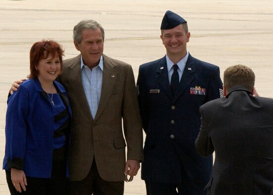 President Bush takes a moment for photographs with Tech. Sgt. Brian Webster and his wife Theresa Webster after presenting the Presidential Service Award to the sergeant. (U.S. Air Force photo by Staff Sgt. Chenzira Mallory)