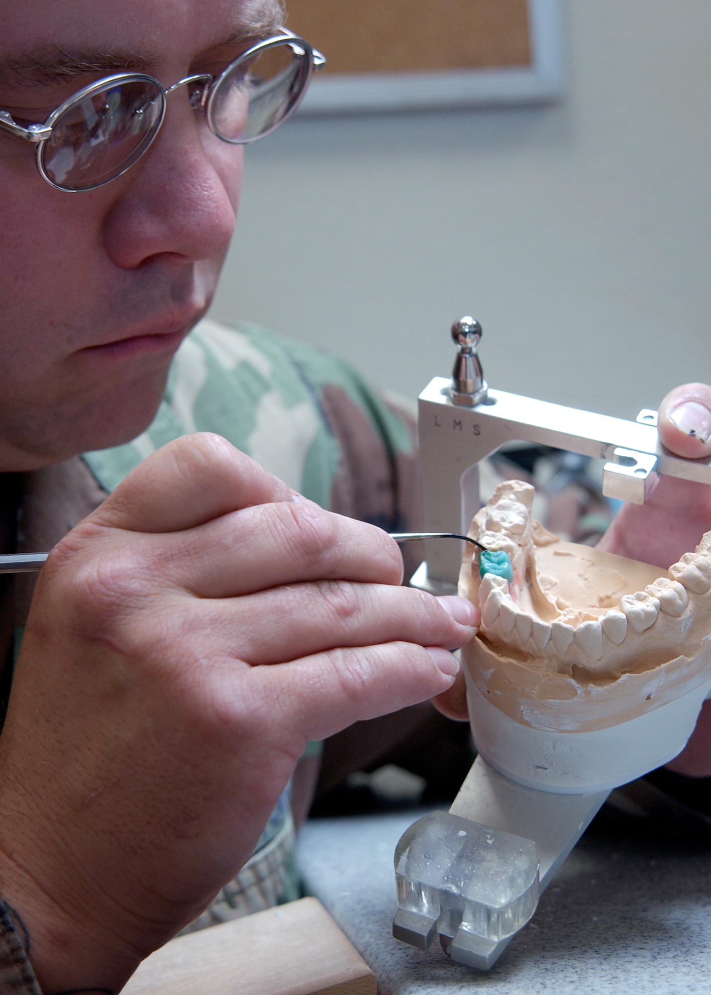 Staff Sgt. Kasey Varvel creates a porcelain dental crown for a patient at Davis-Monthan Air Force Base, Ariz., on Aug. 10. The 355th Dental Squadron provides services for more than 7,000 active-duty Airmen at Davis-Monthan so that they may remain mission ready. (U.S. Air Force photo/Airman Gary Walker)
