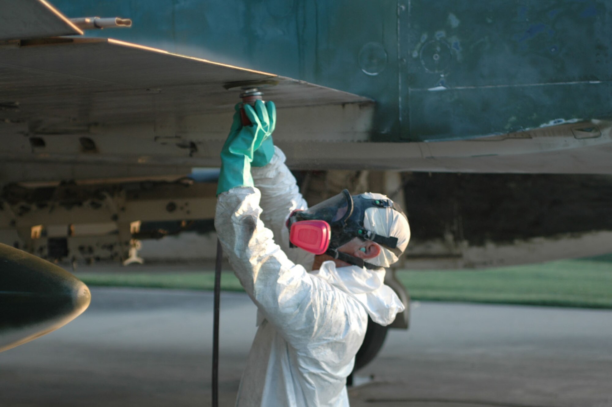 Tech. Sgt. Richard Hunter, 917th Maintenance Squadron aircraft structural mechanic, sands the wing of the static F-4 which sits out in front of the 917th Wing Headquarters building Tuesday, Aug. 15. The F-4 is to be repainted with a Southeast Asia color pattern. (U.S. Air Force photo/Betty Stephens)