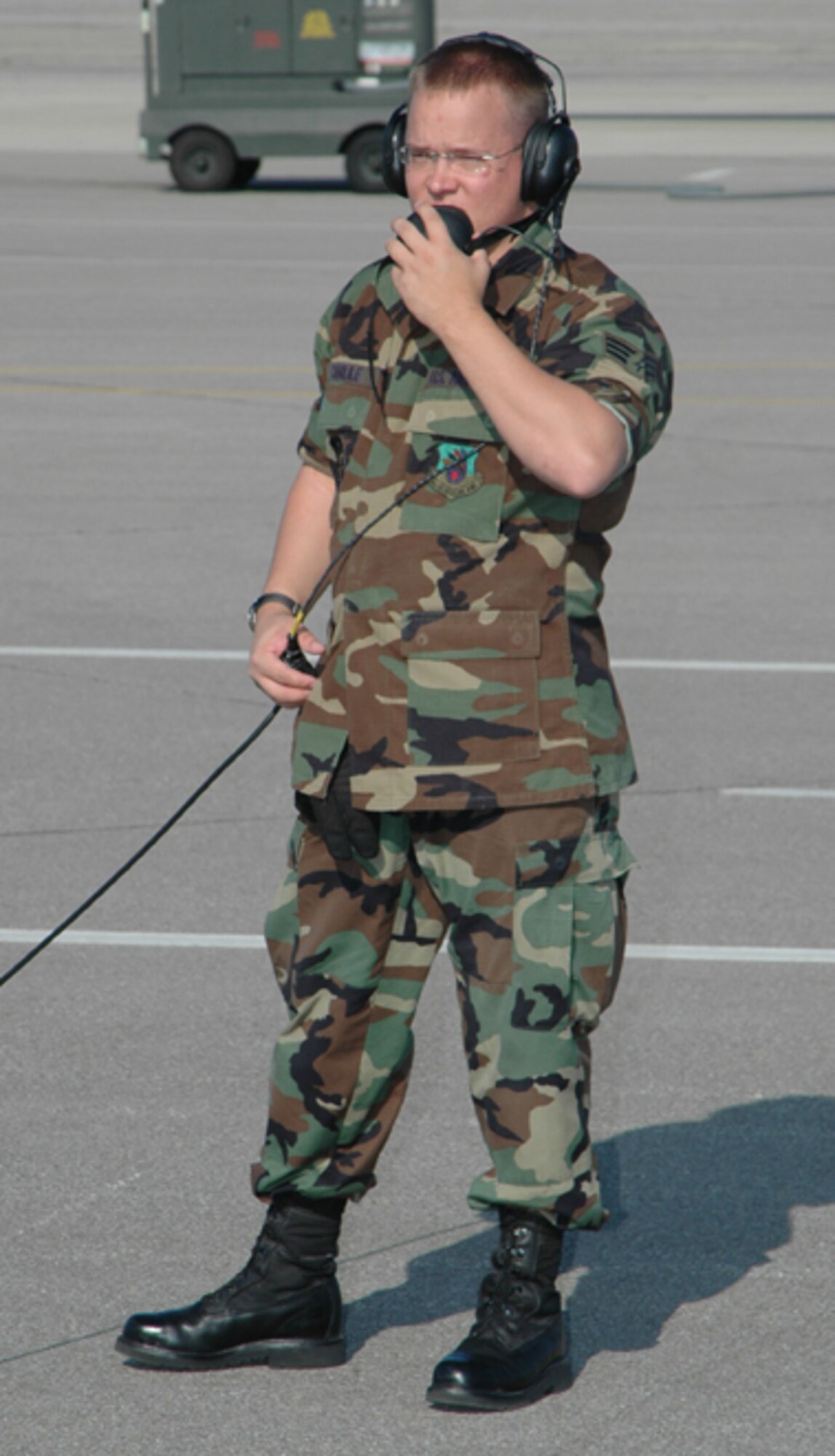GRISSOM AIR RESERVE BASE, Ind -- Senior Airman Wesley Carlile, a KC-135 Crew Chief with the 434th Maintenance Group, uses a hand-held microphone to talk to other maintenance personnel while they work on the Grissom ARB flightline.  (U.S. Air Force Photo/SrA Jonathan Jones)