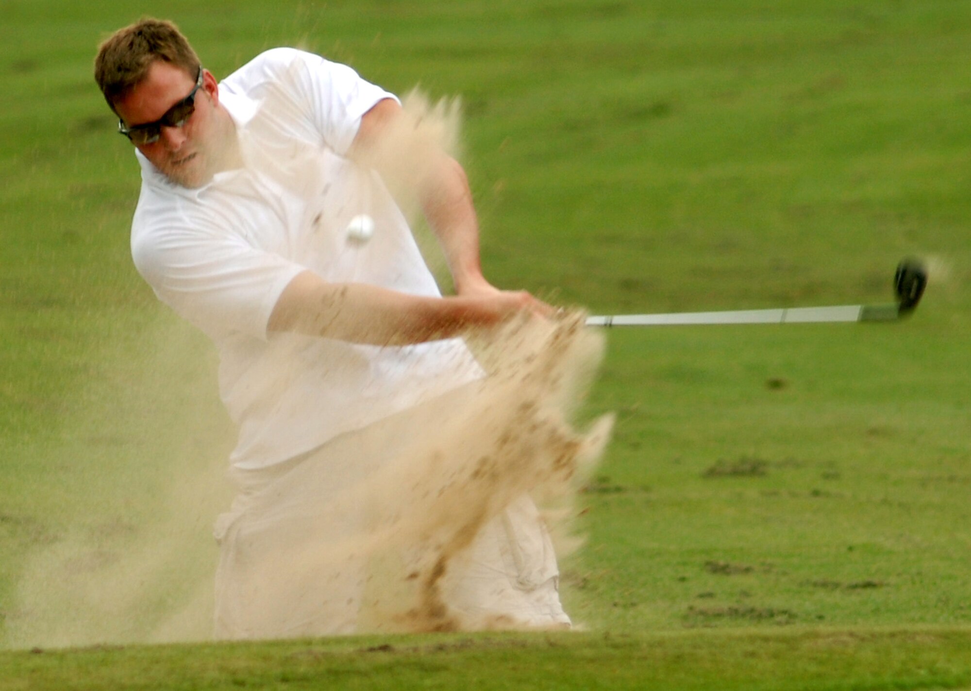 Dan Hubbard, master sergeant and 917th Logistics Readiness Squadron NCOIC,  hits his second shot out of the bunker. The 917th Wing won the championship over defending champions 2d Aircraft Maintenance Squadron. (U.S. Air Force photo/Airman 1st Class Brandon Kusek)