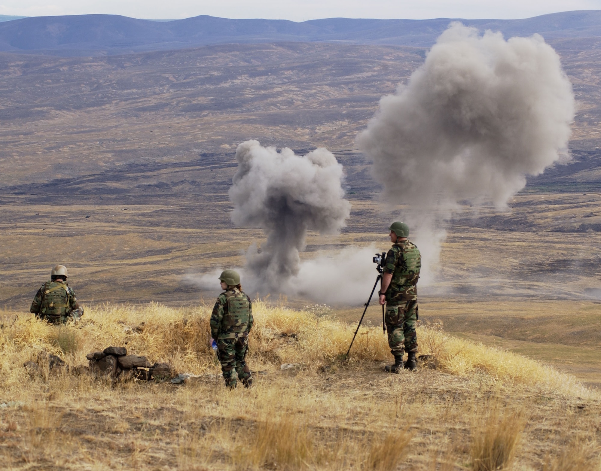 Members of the 47th Fighter Squadron and Air Force Joint Terminal Attack Controllers watch as A-10s drop bombs on the Yakima Range in support of Operation Patriot Knife, Aug. 9. The 47th Fighter Squadron deployed to McChord AFB, Wash., where they dropped live munitions on the Yakima Range for training of the A-10 personnel. (U.S. Air Force photo/Senior Master Sgt. Jessica  D'Aurizio)                                  