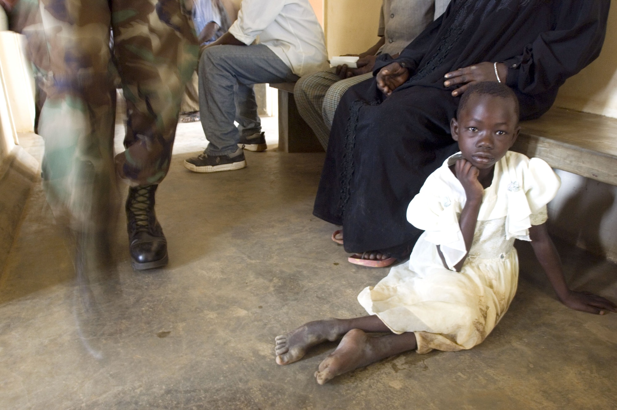 A patient waits on the floor for the next available doctor at a health clinic in Soroti, Uganda, during the training exercise Natural Fire 2006 on Aug. 15. Three East African nations and the United States are participating in the multilateral exercise that is providing medical, veterinary and engineering civil assistance. (U.S. Air Force photo/Master Sgt. John E. Lasky) 
