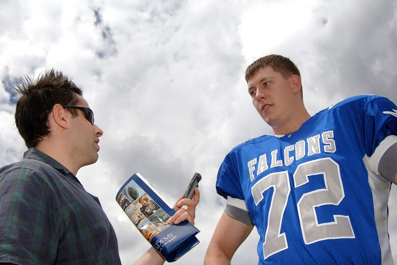 Air Force senior offensive tackle Robert Kraay, wearing the Falcons' new home jersey, talks with Colorado Springs Gazette writer Dan Wolken during media day at the U.S. Air Force Academy. (U.S. Air Force photo/Danny Meyer)