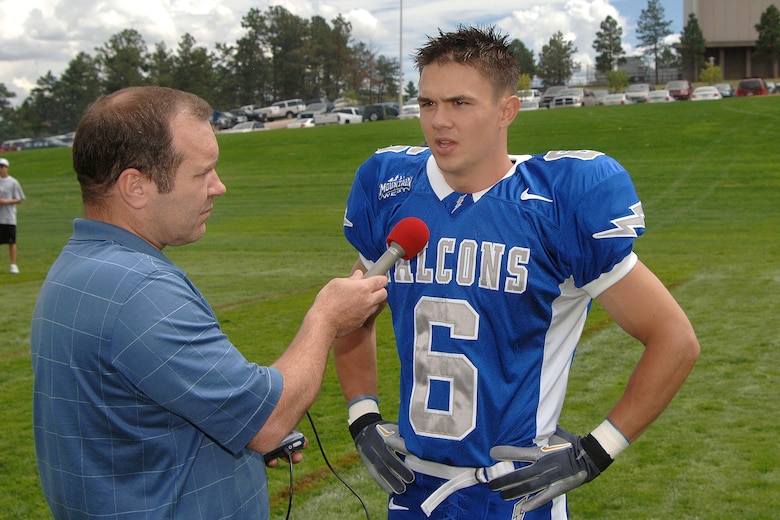 Air Force senior cornerback Chris Sutton, wearing the Falcons' new home jersey, talks with team radio play-by-play announcer Jim Arthur during media day at the U.S. Air Force Academy. (U.S. Air Force photo/Danny Meyer)
