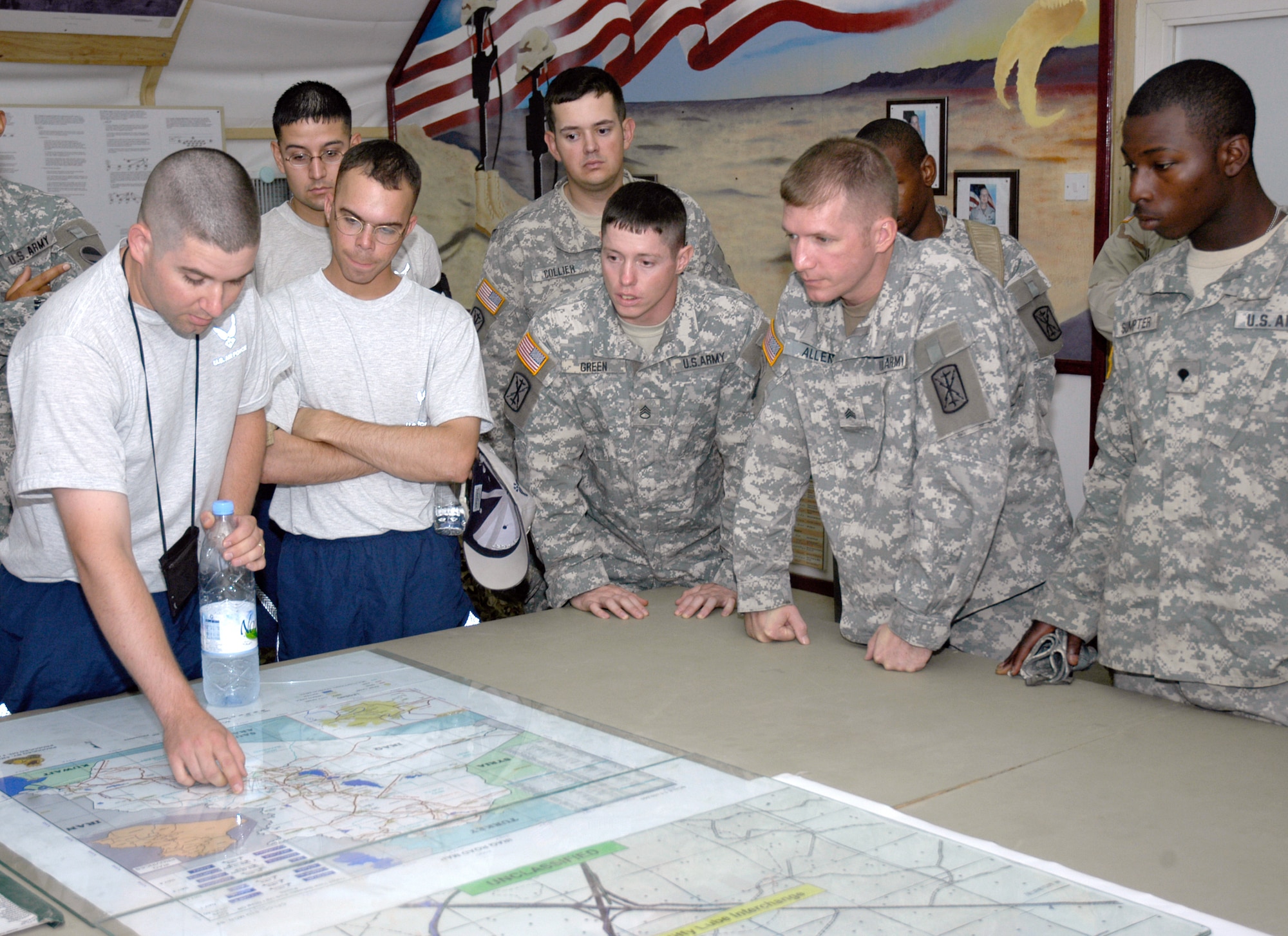 Airmen of the 586th Expeditionary Mission Support Group's 424th Medium Truck Detachment plan a mission with Soldiers from gun truck security command Charlie 1/12. The 424th MTD is responsible for convoy operations in Southwest Asia. (U.S. Air Force photo/Maj. Tom Crosson)