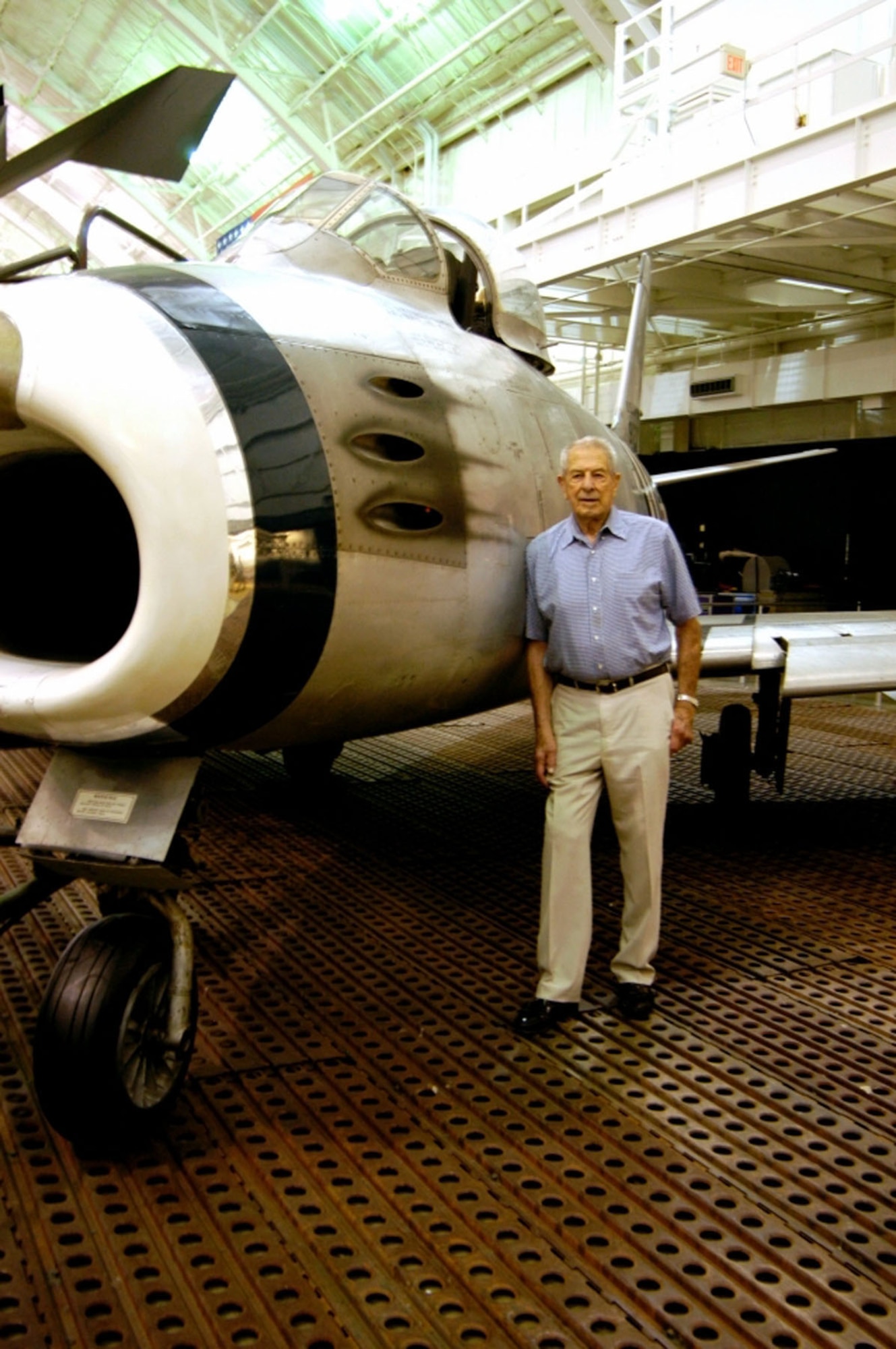 DAYTON, Ohio - Lt. Col. Bruce Hinton stands beside the North American F-86A Sabre in the Korean War Gallery at the National Museum of the U.S. Air Force. The museum's F-86 is is marked as the 4th Fighter Group F-86A flown by Lt. Col. Bruce Hinton on Dec. 17, 1950, when he became the first F-86 pilot to shoot down a MiG. (U.S. Air Force photo)