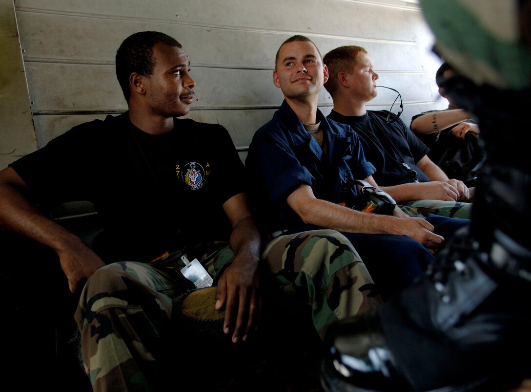 (From left) Airman 1st Class Zachary Pace, Senior Airman Christopher Winfrey and Staff Sgt. Shaun Helmick travel in the back of the crew chief truck before aircraft launches at Langley Air Force Base, Va., on Aug. 15. The Airmen are F-22 Raptor crew chiefs assigned to the 27th Aircraft Maintenance Unit. (U.S. Air Force photo/Staff Sgt. Samuel Rogers) 