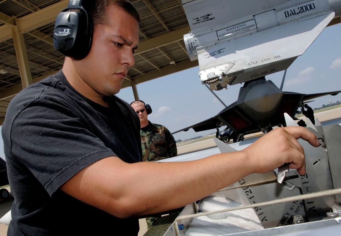 Senior Airman Rafael Hernandez inspects the fin assembly for an AIM-120 missile during a weapons load inspection at Langley Air Force Base, Va., on Aug. 15. Airman Hernandez is a weapons load crew member with the 27th Aircraft Maintenance Unit.(U.S. Air Force photo/Staff Sgt. Samuel Rogers) 