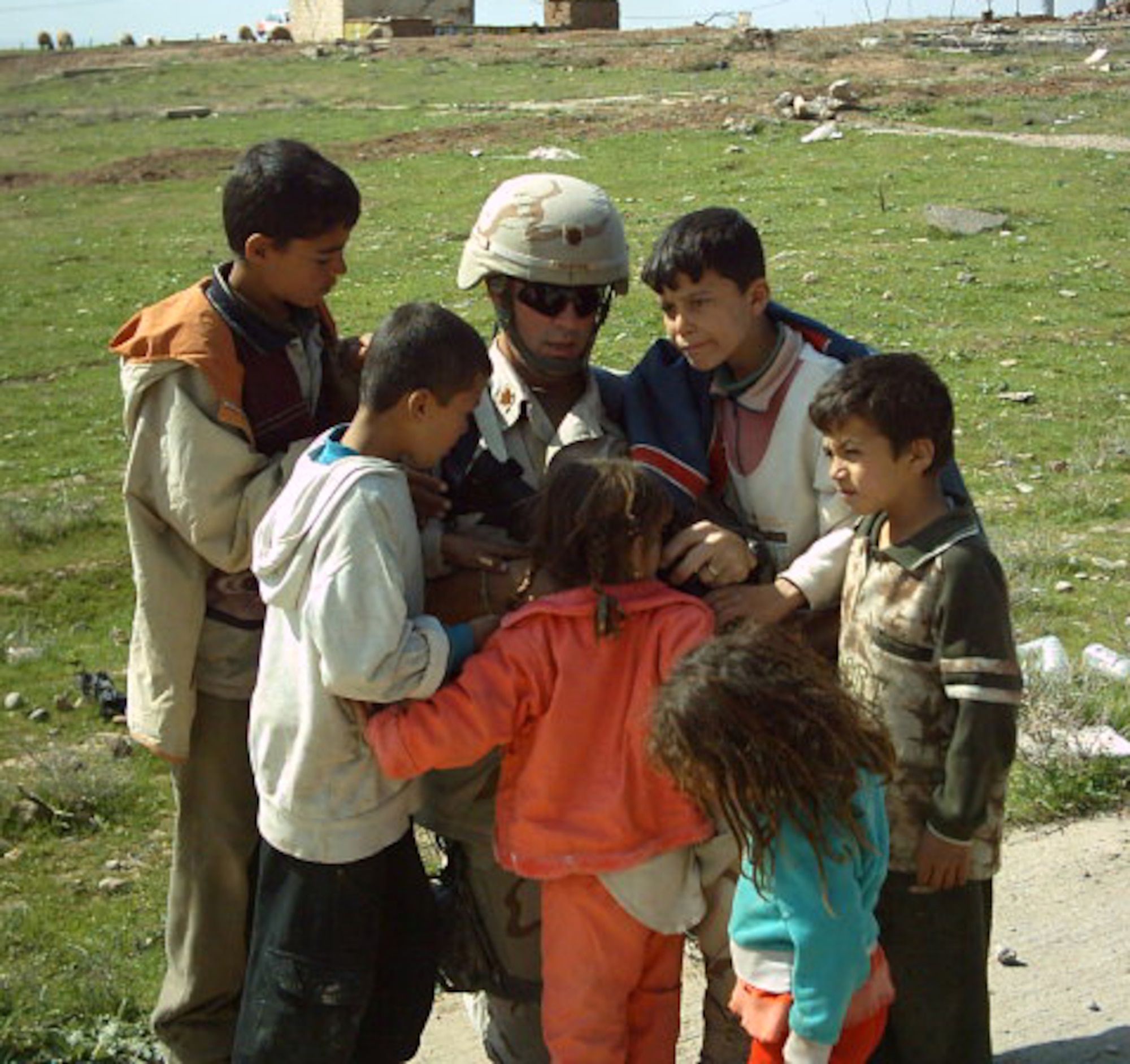 MOODY AIR FORCE BASE, Ga. -- Major Hughes converses with the children of Iraqi soldiers. (Courtesy Photo)