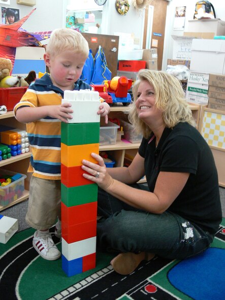 MOODY AIR FORCE BASE, Ga. -- Tammy Turnmeyer, fitness center manager, helps her son Dane build with blocks at the Child Development Center Wednesday. The 347th Medical Group raised $1,051.60, mostly from spare change,during a recent fundraiser to help the Turnmeyer family with Dane's medical expenses. Dane, 3, suffers from a hypoplastic left heart, meaning the left side of his heart doesn't function. (U.S. Air Force photo by Airman 1st Class Eric Schloeffel)