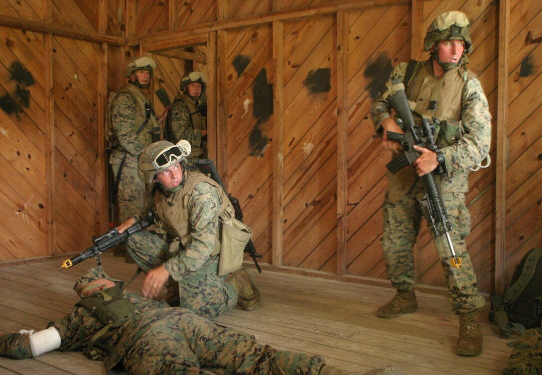 Marines of the 26th MEU react to gunfire during a simulated TRAP mission to recover an injured sniper team August 18, 2006, Camp Lejeune, N.C.  Marines from the Battalion Landing Team, 2nd Bn., 2nd Marine Regiment, and from the 26th MEU's Light Armored Reconnaisance Detachment, participated in a 5-day-course to ready them for surface insertion TRAP missions.